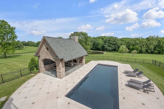 view of pool with a fenced in pool, a yard, a patio area, a fenced backyard, and an outdoor fireplace