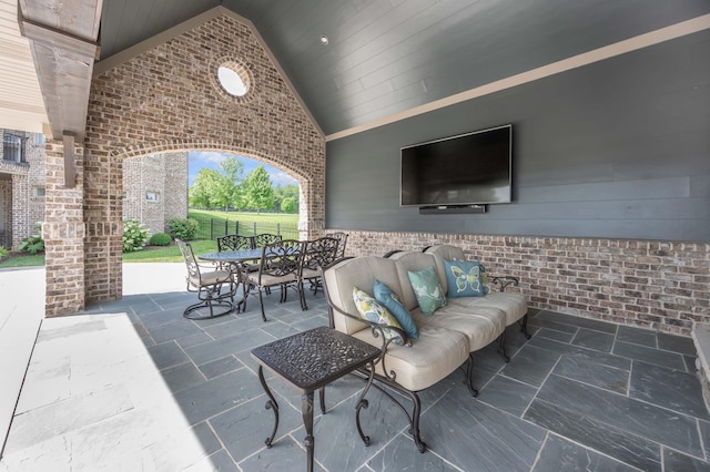 view of patio with outdoor dining area, fence, and an outdoor living space