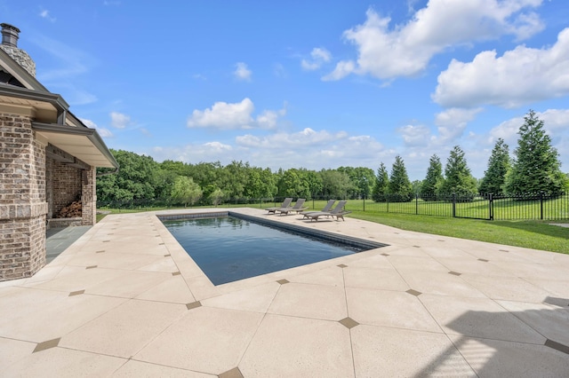 view of pool featuring a patio, a yard, fence, and a fenced in pool