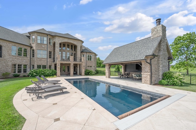 view of swimming pool with a fenced in pool, a patio area, fence, and a lawn