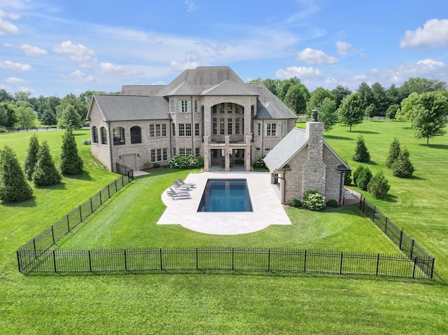 view of swimming pool featuring a patio area, a lawn, and a fenced backyard