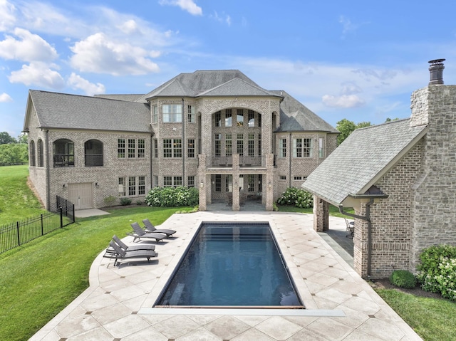 view of pool featuring a lawn, a patio area, fence, and a fenced in pool