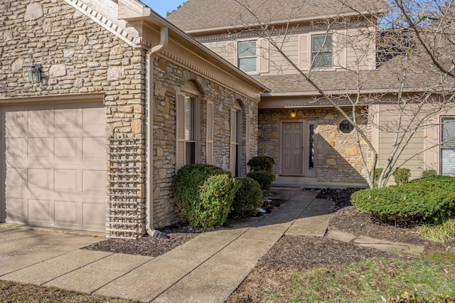 property entrance with a garage, stone siding, and a shingled roof