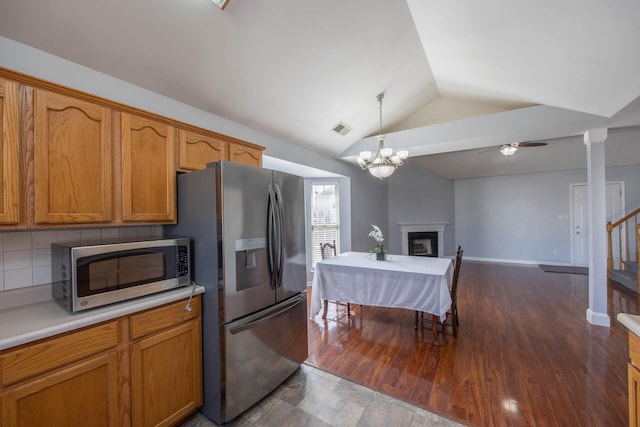 kitchen featuring a fireplace, light countertops, hanging light fixtures, visible vents, and appliances with stainless steel finishes