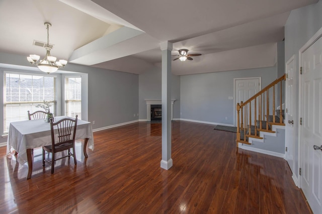 dining area with dark wood-type flooring, stairway, and baseboards