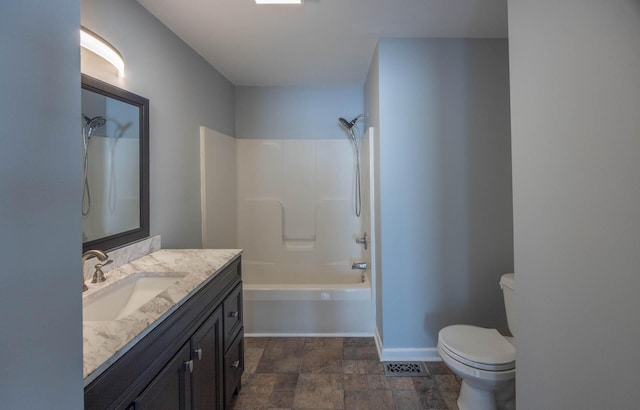 full bathroom with toilet, shower / bath combination, vanity, baseboards, and stone finish floor