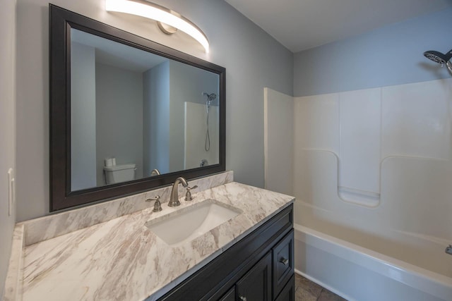 bathroom featuring toilet, bathtub / shower combination, and vanity