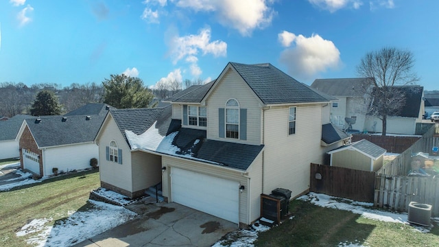 exterior space featuring a garage, central AC, fence, concrete driveway, and a lawn