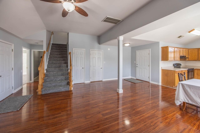 living area with dark wood-style floors, stairs, visible vents, and baseboards