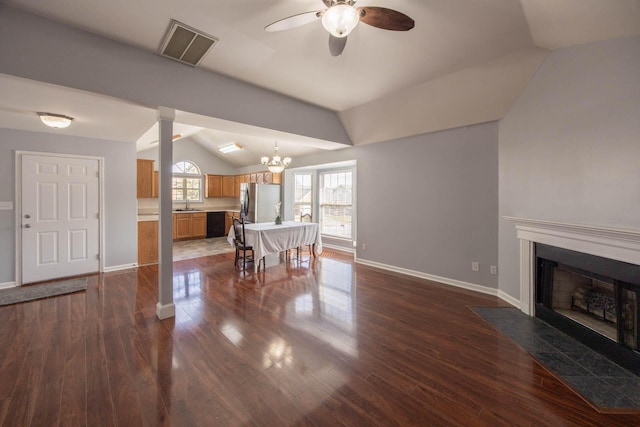 living room with lofted ceiling, dark wood-style flooring, a fireplace with flush hearth, visible vents, and baseboards