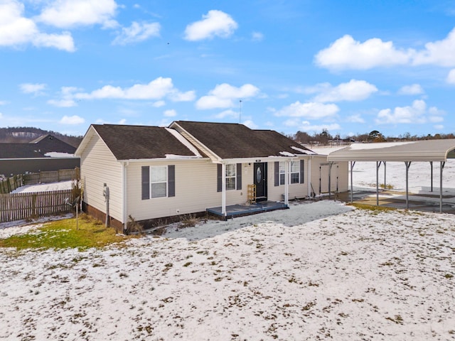 view of front of property featuring fence and a carport