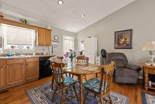 dining area featuring vaulted ceiling, wood finished floors, visible vents, and recessed lighting