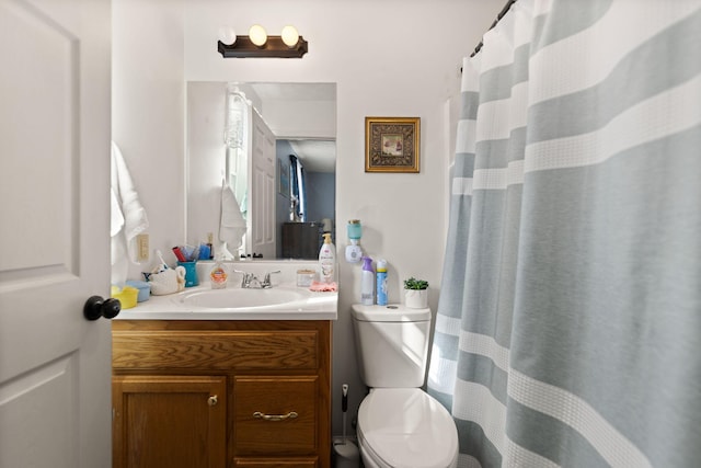 full bath featuring vanity and toilet