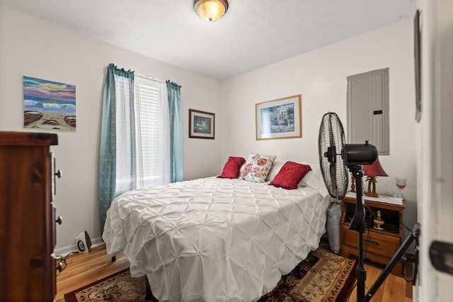 bedroom with wood finished floors and baseboards