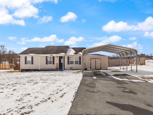 ranch-style home with a carport and fence