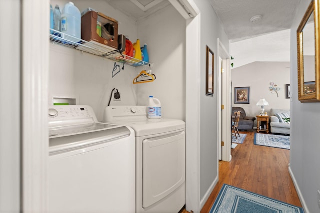 laundry area with laundry area, independent washer and dryer, wood finished floors, and baseboards