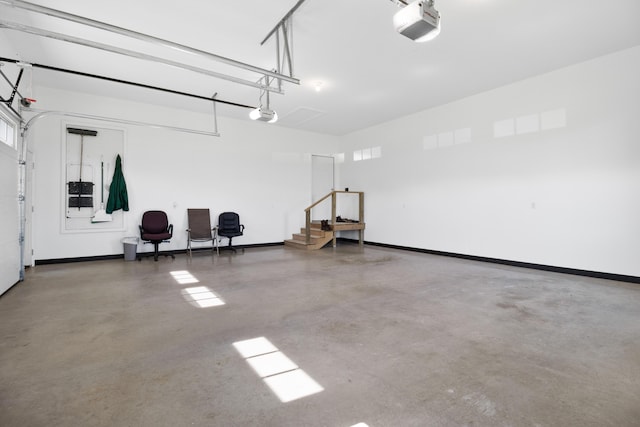 garage with a garage door opener and baseboards