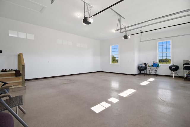 garage with baseboards and a garage door opener