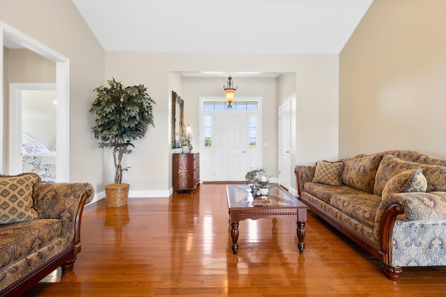 living area featuring baseboards and wood finished floors