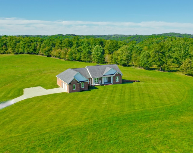 drone / aerial view featuring a forest view