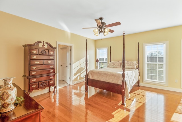 bedroom featuring light wood-type flooring, ceiling fan, and baseboards