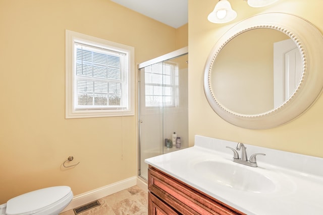 full bathroom featuring visible vents, toilet, a stall shower, vanity, and baseboards