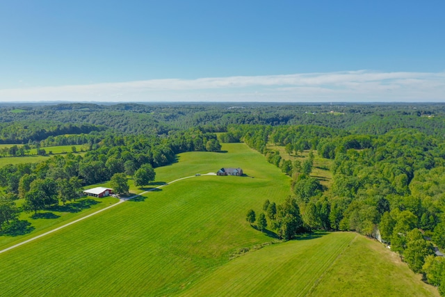 bird's eye view featuring a wooded view and a rural view