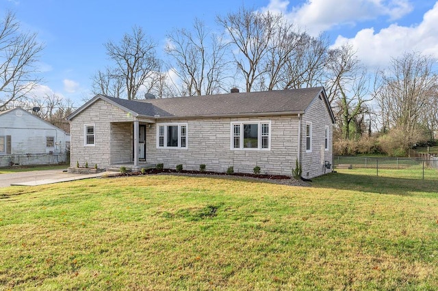 ranch-style home with stone siding, fence, and a front yard