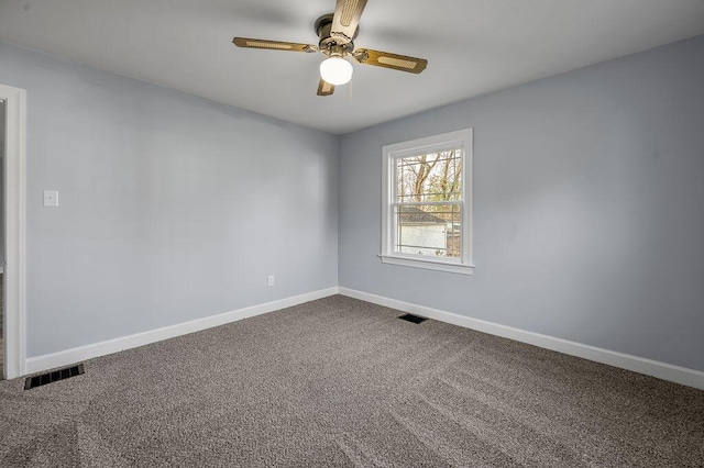 carpeted empty room with a ceiling fan, visible vents, and baseboards