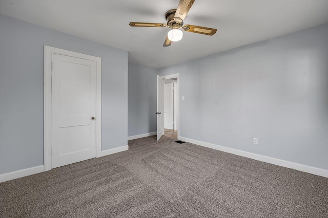 unfurnished bedroom with carpet, visible vents, baseboards, and ceiling fan