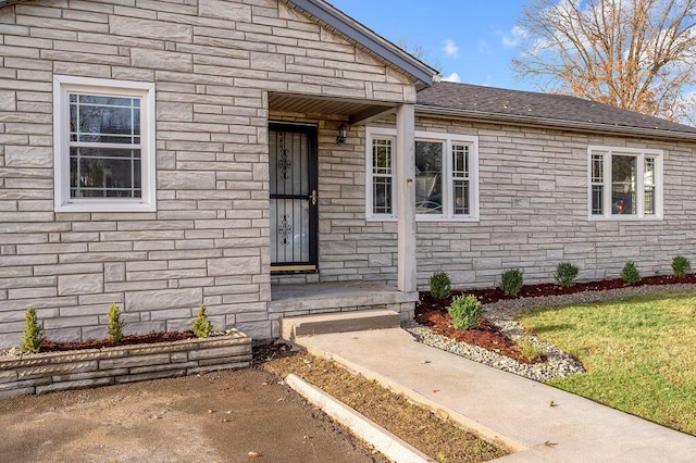 doorway to property featuring roof with shingles