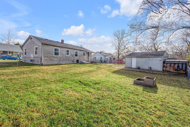 view of yard featuring an outdoor structure and a fenced backyard