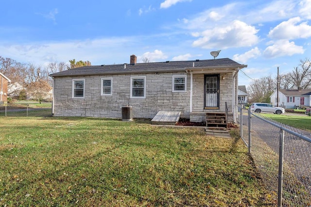 back of property featuring a yard, cooling unit, fence, and entry steps