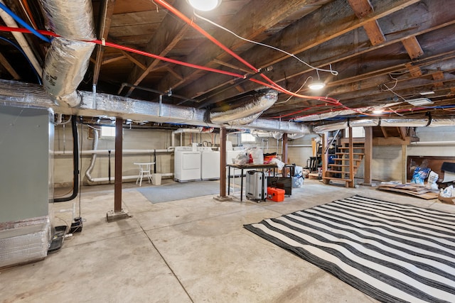 basement with heating unit and washing machine and clothes dryer