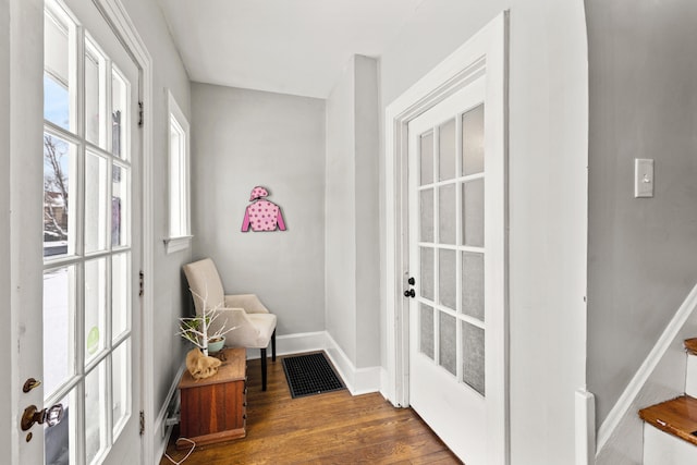 entryway with baseboards, visible vents, and dark wood finished floors