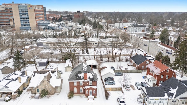 snowy aerial view with a residential view