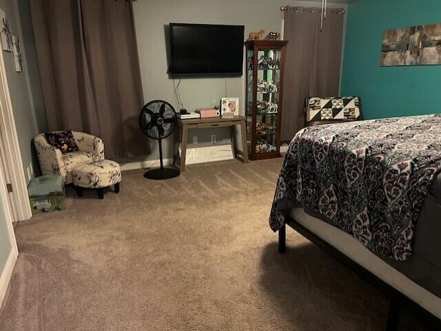 bedroom with carpet and baseboards