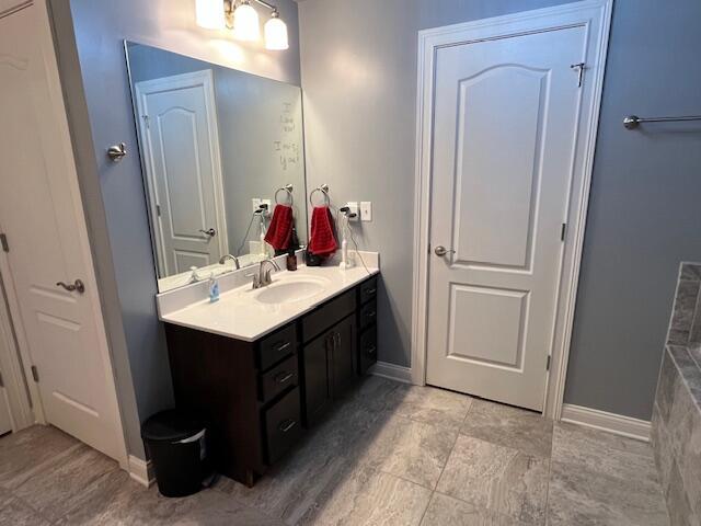 bathroom with vanity and baseboards