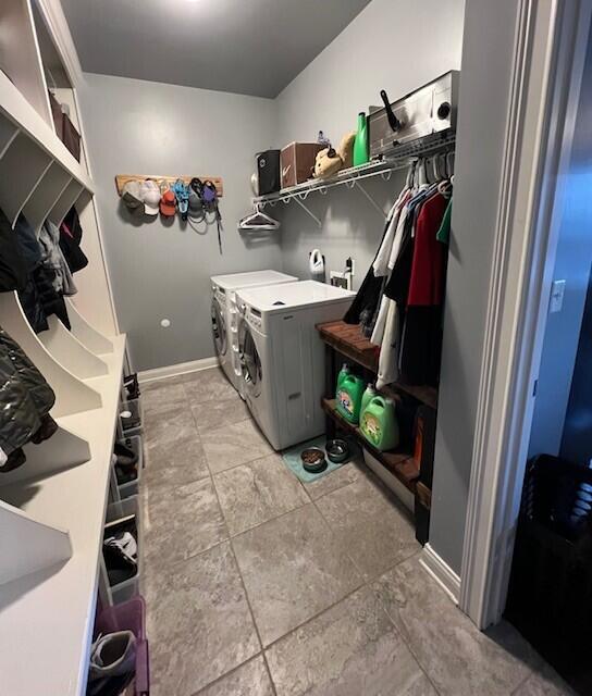 laundry room featuring washing machine and dryer, laundry area, and baseboards