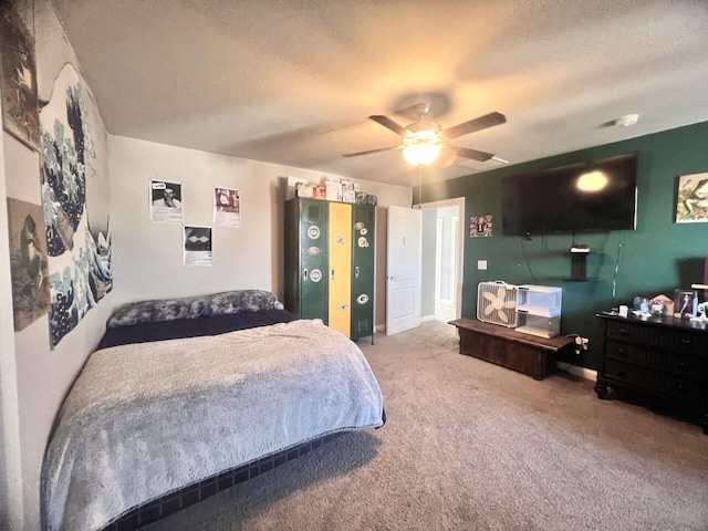 bedroom featuring a textured ceiling, carpet floors, and a ceiling fan