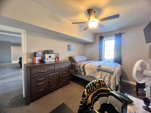 carpeted bedroom featuring baseboards and a ceiling fan