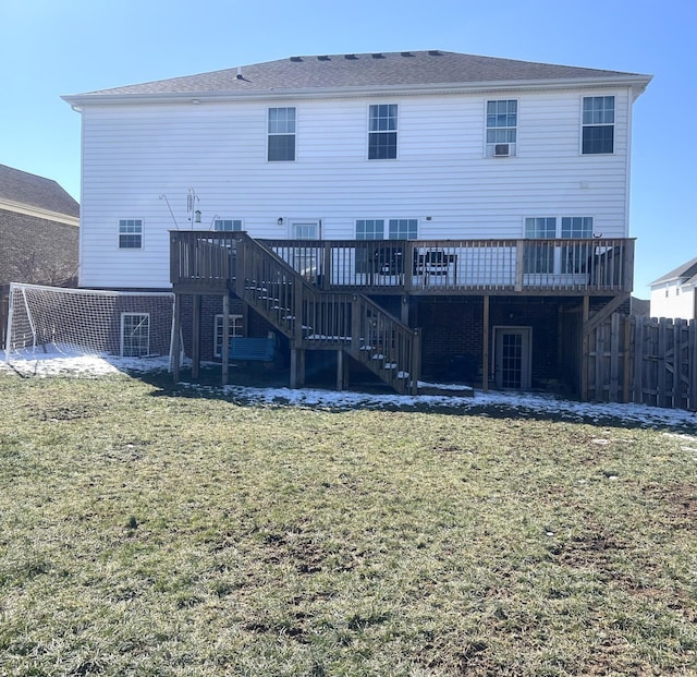 back of property featuring stairs, a yard, fence, and a wooden deck