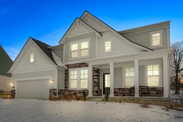 view of front facade featuring covered porch, stone siding, and an attached garage