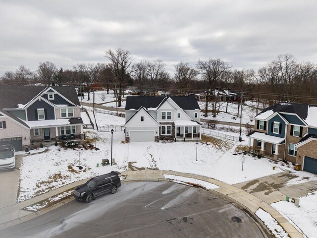 snowy aerial view featuring a residential view