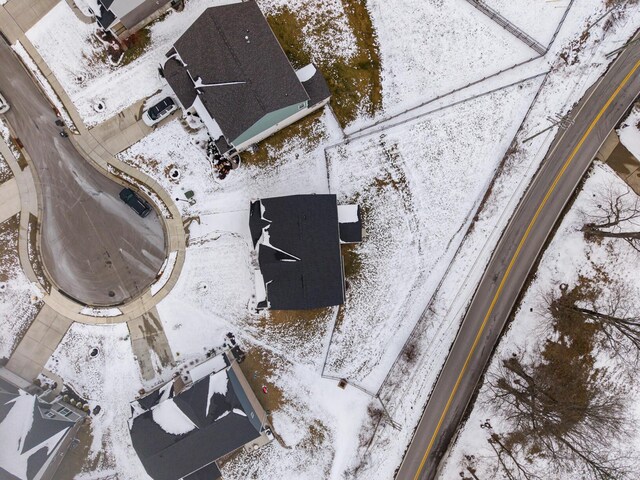 snowy aerial view with a residential view