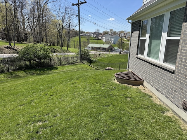 view of yard featuring a fenced backyard and a residential view