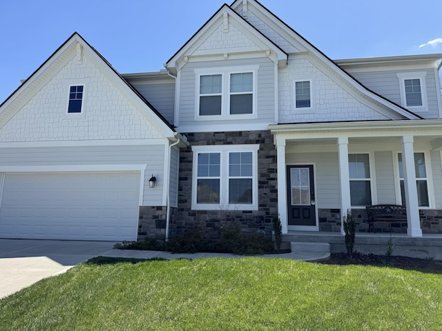 view of front facade featuring a garage, covered porch, stone siding, a front lawn, and concrete driveway