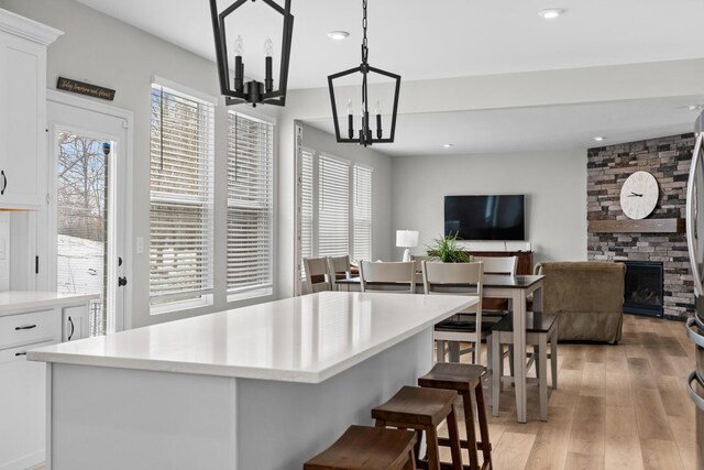 kitchen with white cabinets, stainless steel appliances, light countertops, and open floor plan