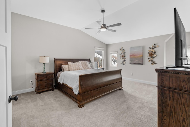 bedroom with light carpet, ceiling fan, baseboards, and lofted ceiling