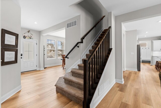 entrance foyer featuring light wood-style flooring and baseboards